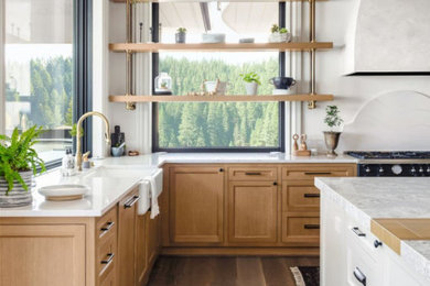 Example of a large mountain style l-shaped light wood floor, white floor and coffered ceiling eat-in kitchen design in San Francisco with light wood cabinets, granite countertops, an island, a farmhouse sink, shaker cabinets, white backsplash, stone slab backsplash, stainless steel appliances and white countertops