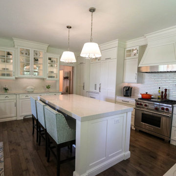 White Kitchen with Gray Quartz Countertops, Farmhouse Sink and Hardwood Floors
