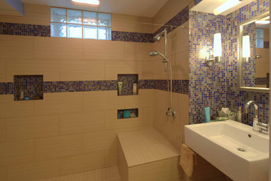 Large modern bathroom in Other with a wall-mount sink, a curbless shower, a one-piece toilet, beige tile, porcelain tile, beige walls and porcelain floors.