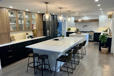 Kitchen - large transitional kitchen idea in Edmonton with shaker cabinets and two islands