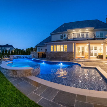 Naperville, IL freeform swimming pool with hot tub, large sunshelf, glass tile