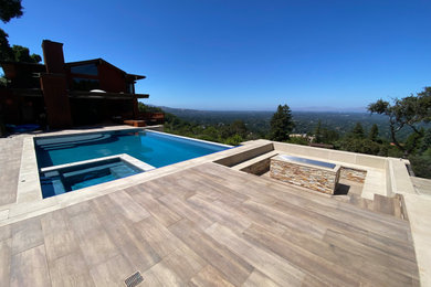 Inspiration for a mid-sized timeless backyard tile and rectangular infinity pool landscaping remodel in San Francisco