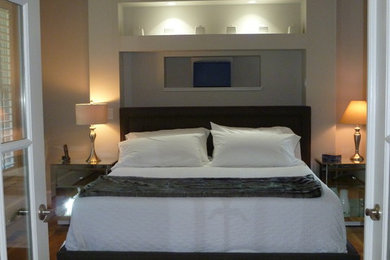 Mid-sized transitional bedroom in Atlanta with grey walls, medium hardwood floors and brown floor.