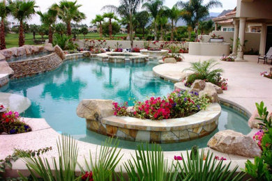 Large tuscan backyard custom-shaped and stone lap pool fountain photo in Other