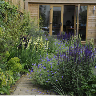 Photo of a small contemporary backyard partial sun garden in London with brick pavers.