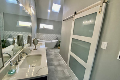 Example of a huge minimalist master ceramic tile, gray floor and double-sink bathroom design in Dallas with blue cabinets, a one-piece toilet, gray walls, an undermount sink, quartz countertops, a hinged shower door, white countertops and a built-in vanity