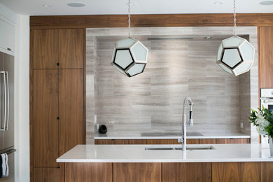 Mid-sized trendy galley eat-in kitchen photo in Other with a double-bowl sink, flat-panel cabinets, medium tone wood cabinets, quartzite countertops, beige backsplash, stainless steel appliances and an island