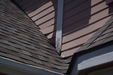 Example of a large ornate blue two-story wood exterior home design in Kansas City with a shingle roof