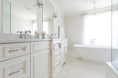 Freestanding bathtub - mid-sized transitional master marble floor and white floor freestanding bathtub idea in Toronto with recessed-panel cabinets, white cabinets, white walls and marble countertops