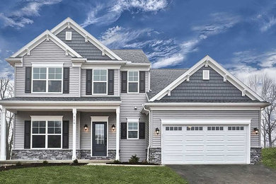 Inspiration for a large timeless gray two-story vinyl exterior home remodel in Other with a shingle roof
