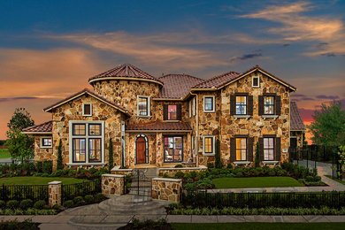 Example of a brown two-story stone exterior home design in Dallas