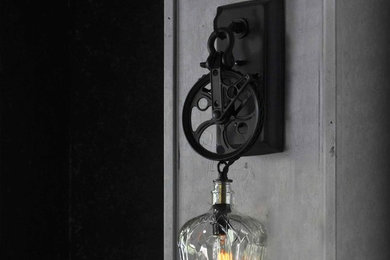 Industrial Pulley Wheel Wall Sconce With Recycled Crown Royal Glass Bottle Lamp