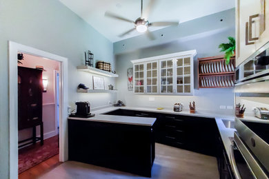 Enclosed kitchen - small traditional l-shaped laminate floor enclosed kitchen idea in Chicago with a single-bowl sink, shaker cabinets, white cabinets, quartz countertops, beige backsplash, ceramic backsplash, stainless steel appliances, no island and white countertops