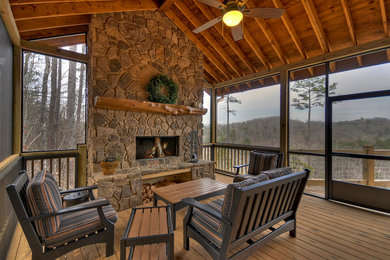 Deck - large rustic backyard deck idea in Atlanta with a roof extension