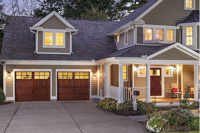 Tuscan attached two-car garage photo in Houston
