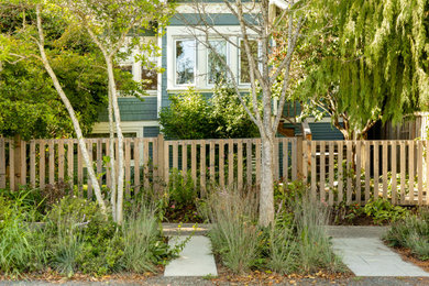Photo of a mid-sized modern drought-tolerant and partial sun backyard stone landscaping in Vancouver for summer.