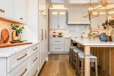 Inspiration for a large modern u-shaped vinyl floor and beige floor eat-in kitchen remodel in Other with an integrated sink, recessed-panel cabinets, white cabinets, quartz countertops, beige backsplash, ceramic backsplash, stainless steel appliances, an island and white countertops