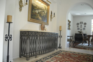 Foyer - mid-sized traditional porcelain tile and beige floor foyer idea in Orange County with white walls