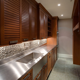 Design ideas for a contemporary galley utility room in DC Metro with louvered cabinets, dark wood cabinets, stainless steel worktops and grey worktops.