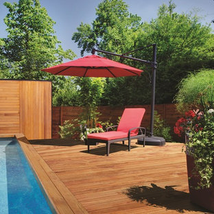 Oberirdischer, Mittelgroßer Moderner Pool hinter dem Haus in rechteckiger Form mit Dielen in Sonstige