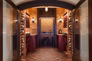Wine cellar - large mediterranean terra-cotta tile wine cellar idea in San Diego