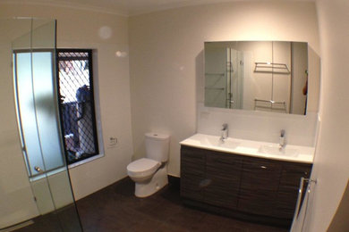 This is an example of a modern 3/4 bathroom in Cairns with a corner shower.