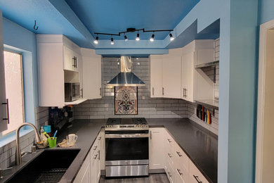 Example of a mid-sized kitchen design in Los Angeles with shaker cabinets and white cabinets