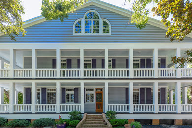 Example of a huge classic gray three-story wood exterior home design in Other with a metal roof