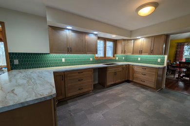Kitchen pantry - large transitional u-shaped kitchen pantry idea in Other with shaker cabinets, light wood cabinets, laminate countertops, green backsplash and mosaic tile backsplash