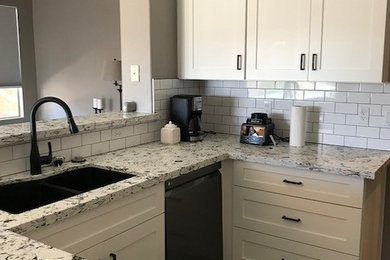 Inspiration for a mid-sized modern u-shaped porcelain tile and brown floor open concept kitchen remodel in Phoenix with an undermount sink, shaker cabinets, white cabinets, quartz countertops, white backsplash, subway tile backsplash, stainless steel appliances and white countertops