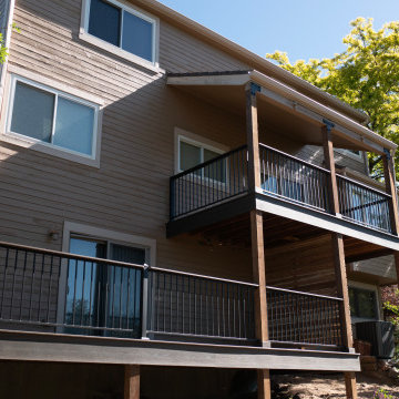 Two-Story Composite Deck With Privacy Wall and Covered Patio