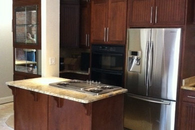 Example of a small eclectic u-shaped eat-in kitchen design in St Louis with an undermount sink, flat-panel cabinets, medium tone wood cabinets, granite countertops and stainless steel appliances
