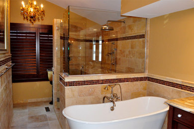 Bathroom - large traditional master brown tile and stone tile beige floor and travertine floor bathroom idea in Minneapolis with brown walls, a hinged shower door, an undermount sink, dark wood cabinets and granite countertops