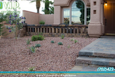 This is an example of a mid-sized traditional courtyard concrete paver retaining wall landscape in Las Vegas.