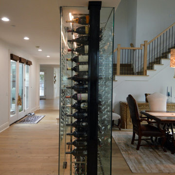 Side View of the Glass Residential Wine Cellars in a Dining Area