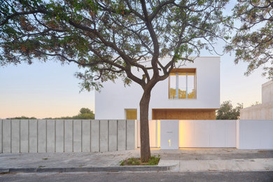 Foto de fachada de casa blanca y blanca moderna de tamaño medio de dos plantas con revestimiento de estuco, tejado plano y tejado de varios materiales