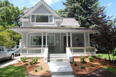 This is an example of a mid-sized traditional concrete paver front porch design in Other with a roof extension.