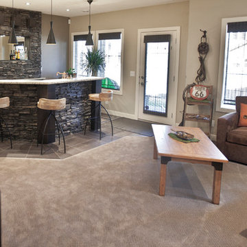 Stone basement wetbar and dark wood cabinetry