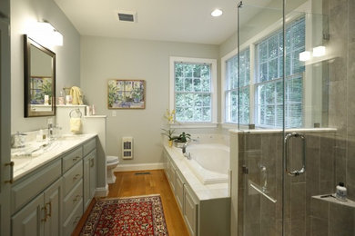 Inspiration for a mid-sized transitional master white tile light wood floor bathroom remodel in San Diego with raised-panel cabinets, gray cabinets, a one-piece toilet, white walls, an undermount sink and marble countertops
