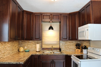 Enclosed kitchen - traditional u-shaped enclosed kitchen idea in Other with raised-panel cabinets, laminate countertops, a double-bowl sink, dark wood cabinets, matchstick tile backsplash, white appliances and no island
