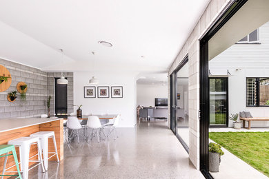 Inspiration for a mid-sized modern open plan dining in Brisbane with white walls and concrete floors.