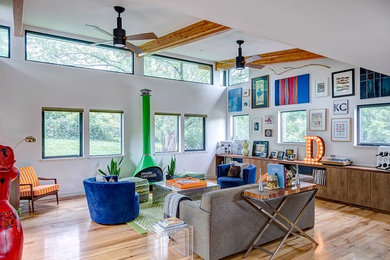Inspiration for a contemporary formal light wood floor living room remodel in Kansas City with white walls, a wood stove and a metal fireplace