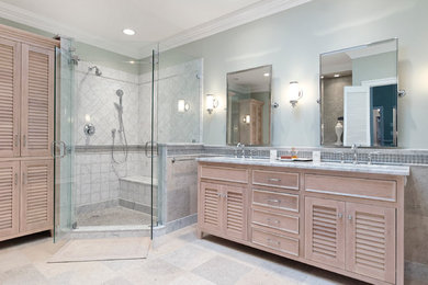 Elegant gray tile and stone tile bathroom photo in DC Metro with an undermount sink, louvered cabinets, light wood cabinets, marble countertops and a two-piece toilet