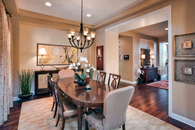 Large zen medium tone wood floor enclosed dining room photo in Los Angeles with beige walls and no fireplace