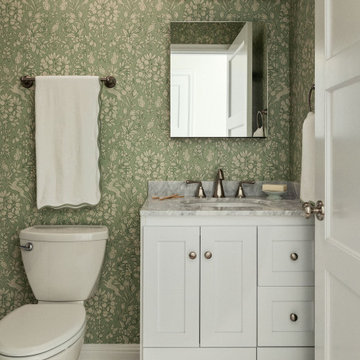 The kids bathroom has charming forest creature wallpaper