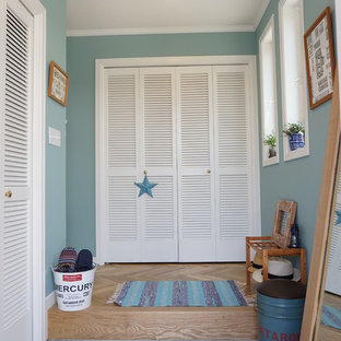 他の地域のトロピカルスタイルのおしゃれな玄関 (青い壁、コンクリートの床) の写真