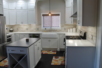 Mid-sized cottage u-shaped medium tone wood floor eat-in kitchen photo in Other with a farmhouse sink, recessed-panel cabinets, white cabinets, quartzite countertops, white backsplash, subway tile backsplash, stainless steel appliances and an island