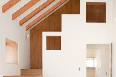 Contemporary wood u-shaped staircase in Tokyo with wood risers.
