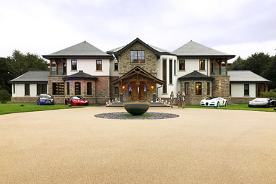 This is an example of an expansive contemporary two-storey white house exterior in Other with mixed siding, a hip roof and a shingle roof.