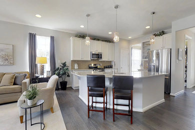 Example of a large classic u-shaped medium tone wood floor and brown floor open concept kitchen design in Wilmington with a single-bowl sink, recessed-panel cabinets, white cabinets, granite countertops, beige backsplash, subway tile backsplash, stainless steel appliances and an island
